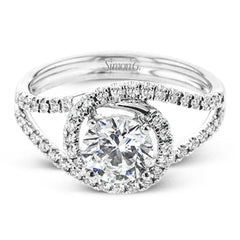 Crafted in the highest quality platinum, this engagement ring design features a two overlapping loops encircling the center stone set with .25 ctw of white diamonds.