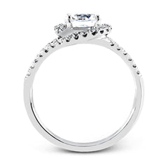 Crafted in the highest quality platinum, this engagement ring design features a two overlapping loops encircling the center stone set with .25 ctw of white diamonds.