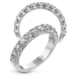 This classic wedding band features a distinctive setting style that shows off the .97 ctw of white diamonds to their full advantage.