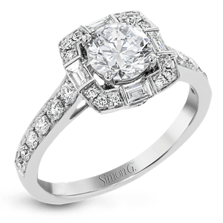 This sleek, contemporary white gold engagement ring contains .35 ctw of round white diamonds and .19 ctw of baguette shaped diamonds on its shank and unique, geometric halo