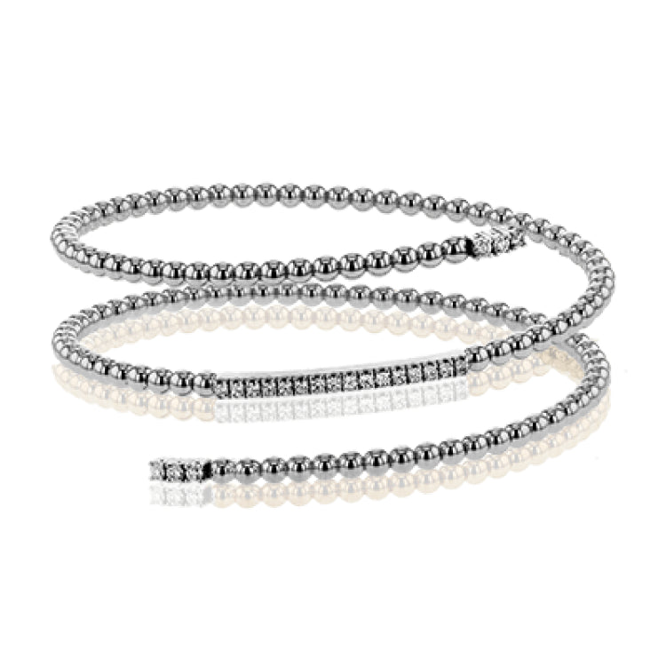 This fun 18k rose gold bangle is formed in a spiral shape and contains .42 ctw of brilliant white diamonds. Perfect for stacking.