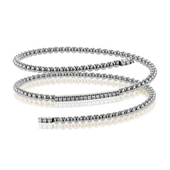 This fun 18k rose gold bangle is formed in a spiral shape and contains .42 ctw of brilliant white diamonds. Perfect for stacking.