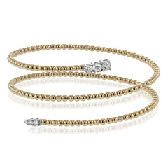 This spiral bangle look great stacked but also makes the perfect statement on its own. It contains a total of .54 ctw of white diamonds.