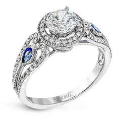 This intricate vintage-inspired engagement ring has two accent sapphire side stone totaling .25 ctw, while .33 ctw of white diamonds sparkle on the rest of the setting.