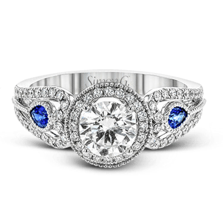 This intricate vintage-inspired engagement ring has two accent sapphire side stone totaling .25 ctw, while .33 ctw of white diamonds sparkle on the rest of the setting.