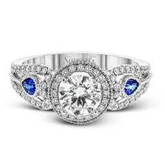 This intricate vintage-inspired engagement ring has two accent sapphire side stone totaling .25 ctw, while .33 ctw of white diamonds sparkle on the rest of the setting.