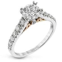 This beautiful white gold engagement ring is set with .55 ctw of round white diamonds flanking the center stone, as well as a distinctive rose gold accent