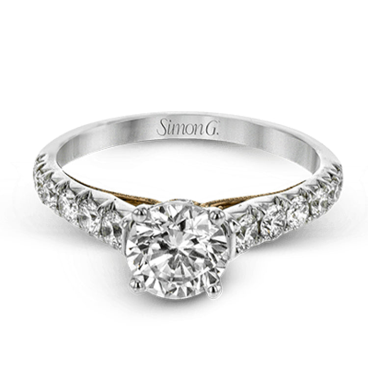 This beautiful white gold engagement ring is set with .55 ctw of round white diamonds flanking the center stone, as well as a distinctive rose gold accent