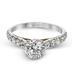This beautiful white gold engagement ring is set with .55 ctw of round white diamonds flanking the center stone, as well as a distinctive rose gold accent