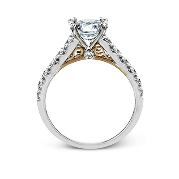 This beautiful white gold engagement ring is set with .55 ctw of round white diamonds flanking the center stone, as well as a distinctive rose gold accent