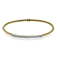This 18k 2t white and yellow gold bangle is incredibly easy to wear, while providing a complete dose of style with .24 ctw of white diamonds. Perfect for stacking.