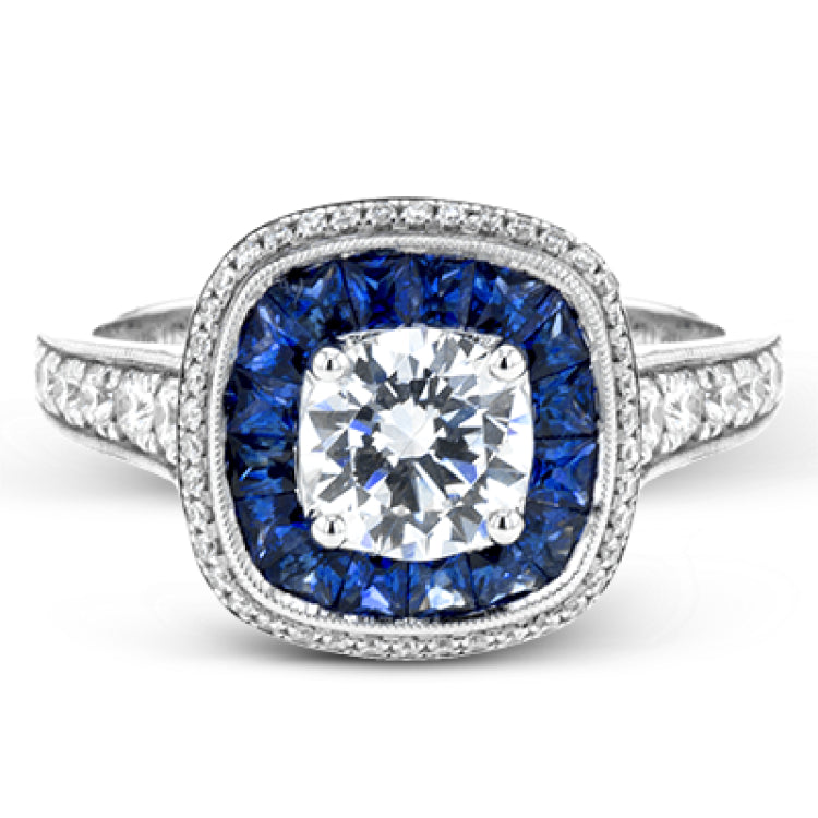 Specially shaped sapphires formed a halo around the center stone in this remarkable engagement ring, accented by .42 ctw of white diamonds as well.