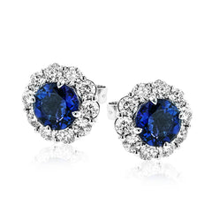 These lovely, vintage-inspired white gold earrings feature 1.15 ctw of sapphires framed by halos containing 1.17 ctw of round white diamonds.