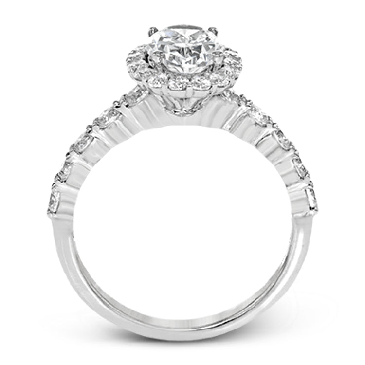 This white gold ring's clean, modern design features a halo and shank that dazzle with .70 ctw of round white diamonds.