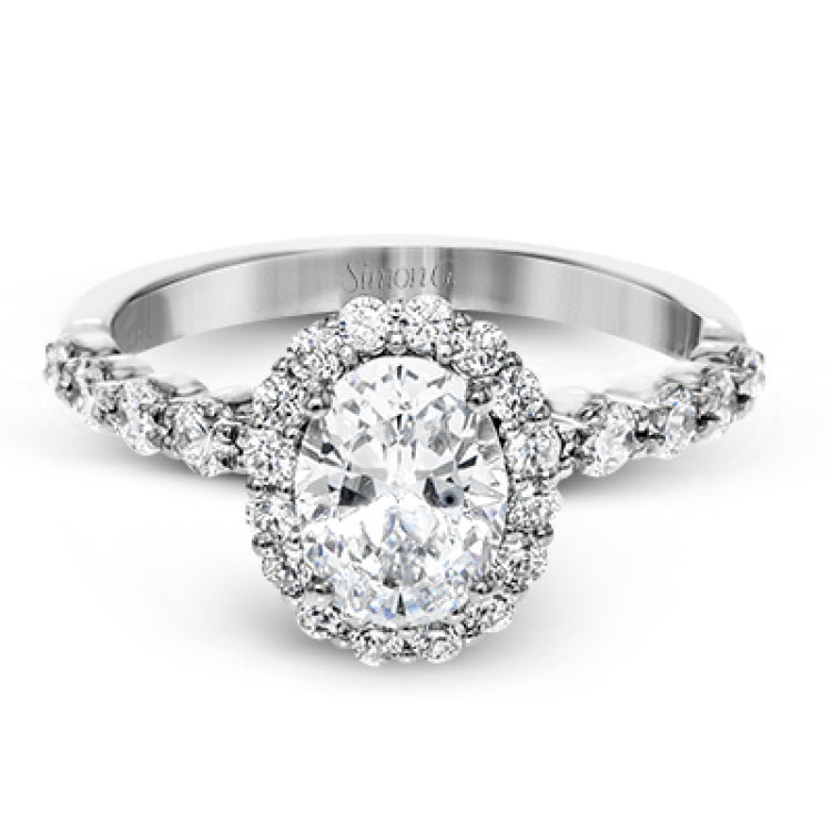 This white gold ring's clean, modern design features a halo and shank that dazzle with .70 ctw of round white diamonds.