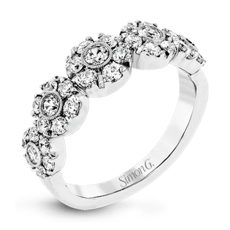 This whimsical white gold ring features .78 ctw of round white diamonds accentuated by .07 ctw of round pink diamonds as well as rose gold details in a playful floral design.