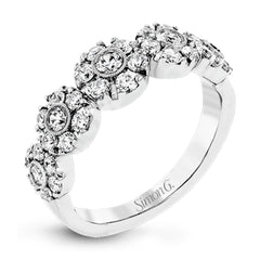 This whimsical white gold ring features .78 ctw of round white diamonds accentuated by .07 ctw of round pink diamonds as well as rose gold details in a playful floral design.