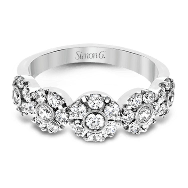 This whimsical white gold ring features .78 ctw of round white diamonds accentuated by .07 ctw of round pink diamonds as well as rose gold details in a playful floral design.