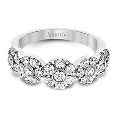 This whimsical white gold ring features .78 ctw of round white diamonds accentuated by .07 ctw of round pink diamonds as well as rose gold details in a playful floral design.