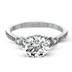 Timelessly beautiful, this white gold engagement ring's stunning design features .44 ctw of round white diamonds flanking the center stone with a lovely tapered effect.