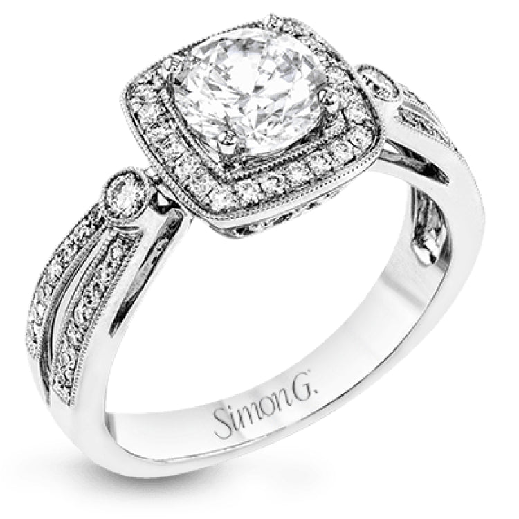 This wonderful 18k white gold ring has a distinctive design with a soft square halo and .34 ctw of white diamonds.
