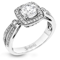 This wonderful 18k white gold ring has a distinctive design with a soft square halo and .34 ctw of white diamonds.