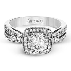 This wonderful 18k white gold ring has a distinctive design with a soft square halo and .34 ctw of white diamonds.