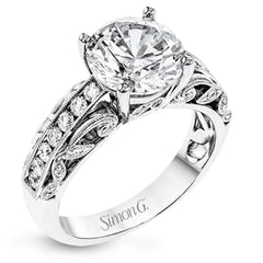 This 18k white gold engagement ring has a design taken from nature with leaves and filigree set with .43 ctw of white diamonds.