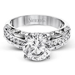 This 18k white gold engagement ring has a design taken from nature with leaves and filigree set with .43 ctw of white diamonds.