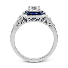 This 18k white gold engagement setting would be a perfect 'something blue' with .79 ctw of baguette sapphires in a halo surrounding the center stone. These are framed by .33 ctw of princess cut diamonds and .11 ctw of round brilliant diamonds.