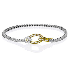 This two tone 18k white and rose gold buckle bracelet contains .98 ctw of white round brilliant diamonds, a .02 ct pink diamond, and a tiny flower design.