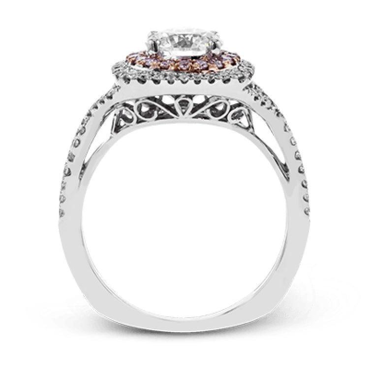 This lovely halo engagement ring is crafted in tones of 18k rose and white gold and contains .36 ctw of white diamonds along with .18 ctw of pink diamonds.