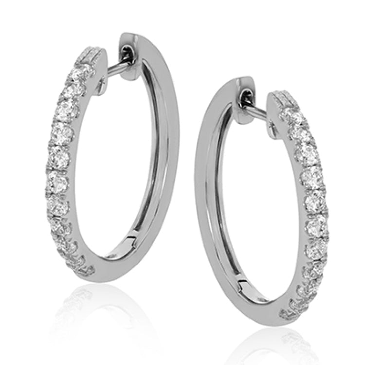 These 18k white gold medium-sized hoop earrings feature a setting style which shows off .61 ctw of  shining white diamonds.