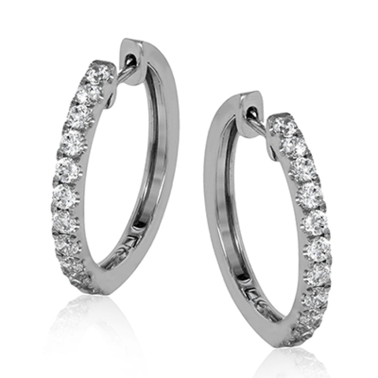 These timeless hoop earrings are set with a stunning 1.01 ctw of round white diamond and crafted from 18k white gold.