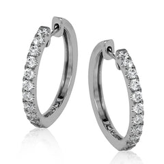 These timeless hoop earrings are set with a stunning 1.01 ctw of round white diamond and crafted from 18k white gold.