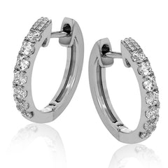These petite hoop earrings are formed in 18k white gold and set with .30 ctw of scintillating round white diamonds.
