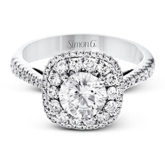 This 18k white gold engagement ring setting has a stunning double halo design set with .61 ctw of shining white round brilliant diamonds.