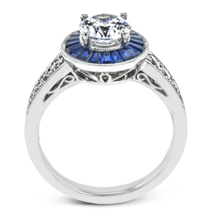 This 18k white gold engagement ring add something special with .56 ctw of baguette sapphires in a halo around the center stone. A total of .36 ctw of white diamonds finish this remarkable design.