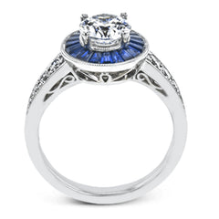 This 18k white gold engagement ring add something special with .56 ctw of baguette sapphires in a halo around the center stone. A total of .36 ctw of white diamonds finish this remarkable design.