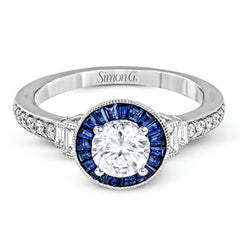 This 18k white gold engagement ring add something special with .46 ctw of baguette sapphires in a halo around the center stone. A total of .13 ctw of white diamonds and an additional .13 ctw of baguette diamonds finish this remarkable design.