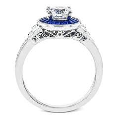 This 18k white gold engagement ring add something special with .46 ctw of baguette sapphires in a halo around the center stone. A total of .13 ctw of white diamonds and an additional .13 ctw of baguette diamonds finish this remarkable design.