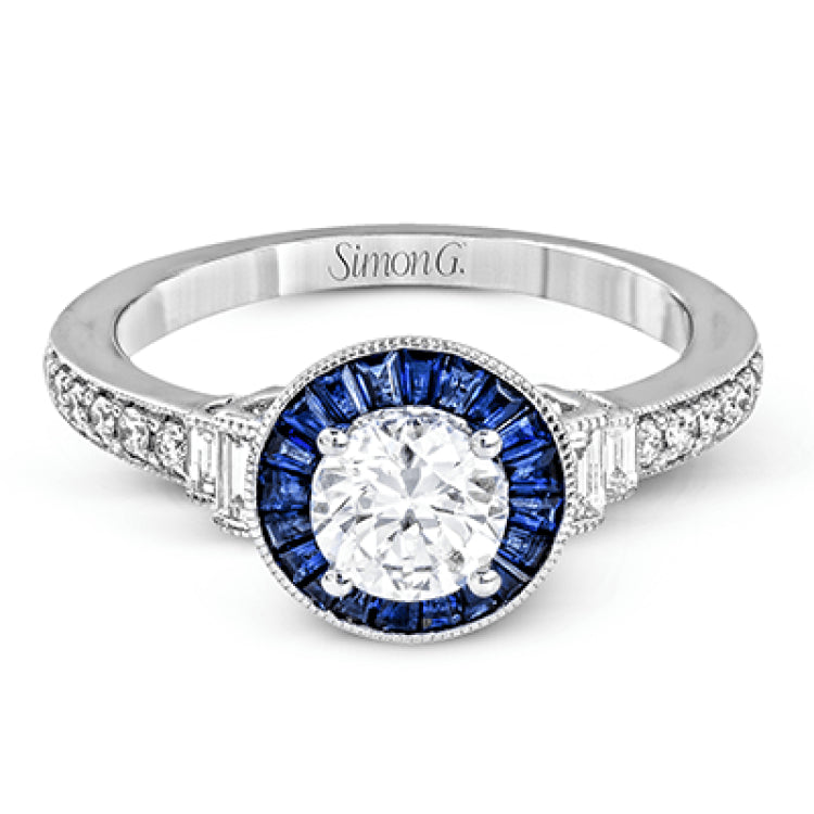 This 18k white gold engagement ring add something special with .46 ctw of baguette sapphires in a halo around the center stone. A total of .13 ctw of white diamonds and an additional .13 ctw of baguette diamonds finish this remarkable design.