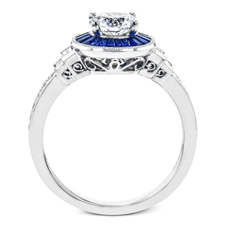 This 18k white gold engagement ring add something special with .46 ctw of baguette sapphires in a halo around the center stone. A total of .13 ctw of white diamonds and an additional .13 ctw of baguette diamonds finish this remarkable design.