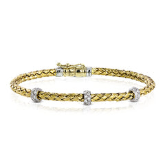 This wonderful 18k yellow gold woven bracelet contains .33 ctw of white diamonds, adding an opulent touch which can still be worn everyday. Perfect for stacking.