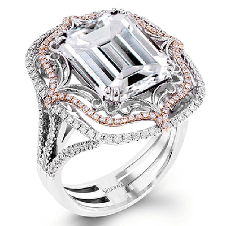 This vintage-inspired two-tone 18k gold ring centers on an extraordinary 7.03 rubellite stone which is surrounded by .67 ctw of white diamonds.