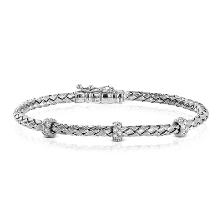 This woven 18k white gold bracelet is ideal for layering, but can also stand on its own. A total of .33 ctw of white diamonds add sparkle to this piece. Perfect for stacking.