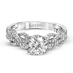 This distinctive 18k white gold ring has an intricate design reminiscent of lover's knots and eternity symbols, set with .33 ctw of white diamonds.