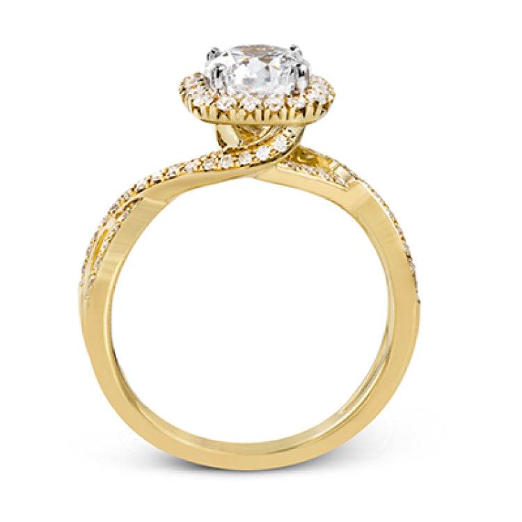 This sparkling modern engagement ring features an eye-catching twisted design with elegant classic halo accented by .29 ctw of shimmering round cut white diamonds.