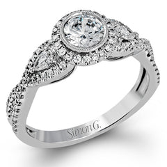 This 18k white gold wedding set has a distinctive design with a milgrain accented bezel center stone setting, .15 ctw pear side stones, and .50 ctw of round brilliant diamonds.