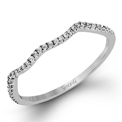 This 18k white gold wedding set has a distinctive design with a milgrain accented bezel center stone setting, .15 ctw pear side stones, and .50 ctw of round brilliant diamonds.
